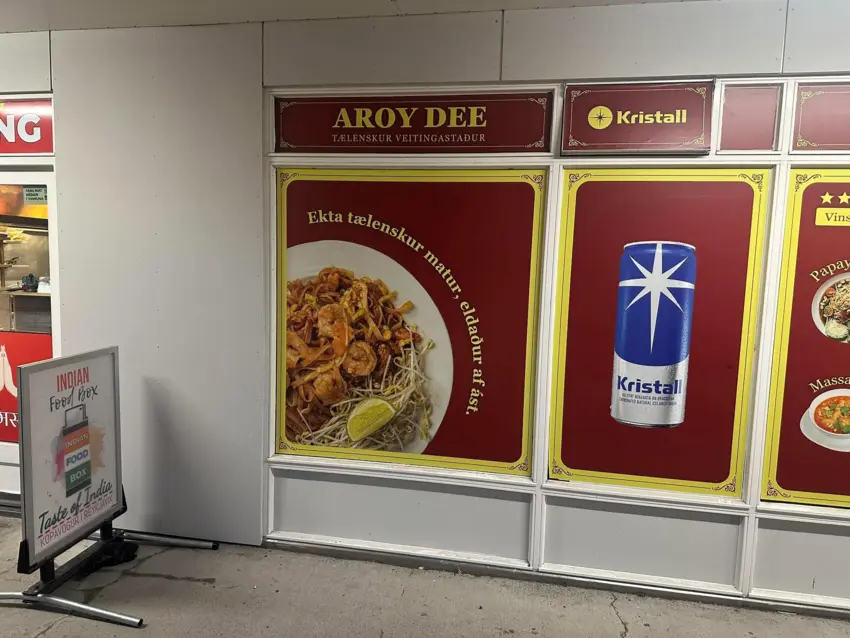 Aroy Dee's Thai food sign beside the Indian Food Box pavement board